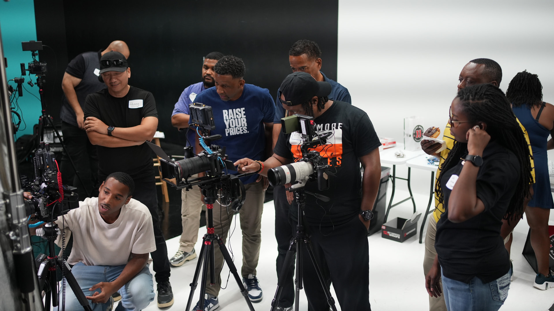 Cohort gathered around cameras reviewing footage
