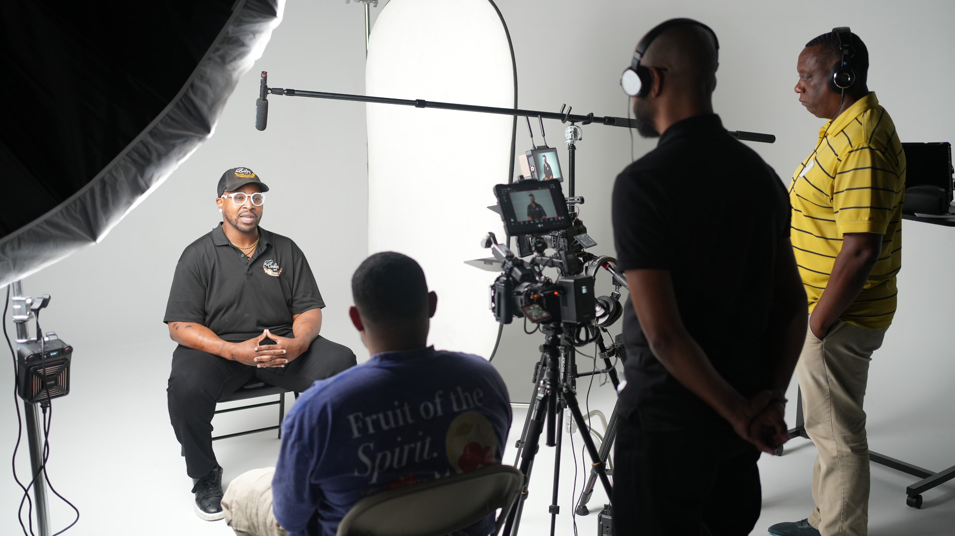 Workshop attendees filming a business owner on a white backdrop